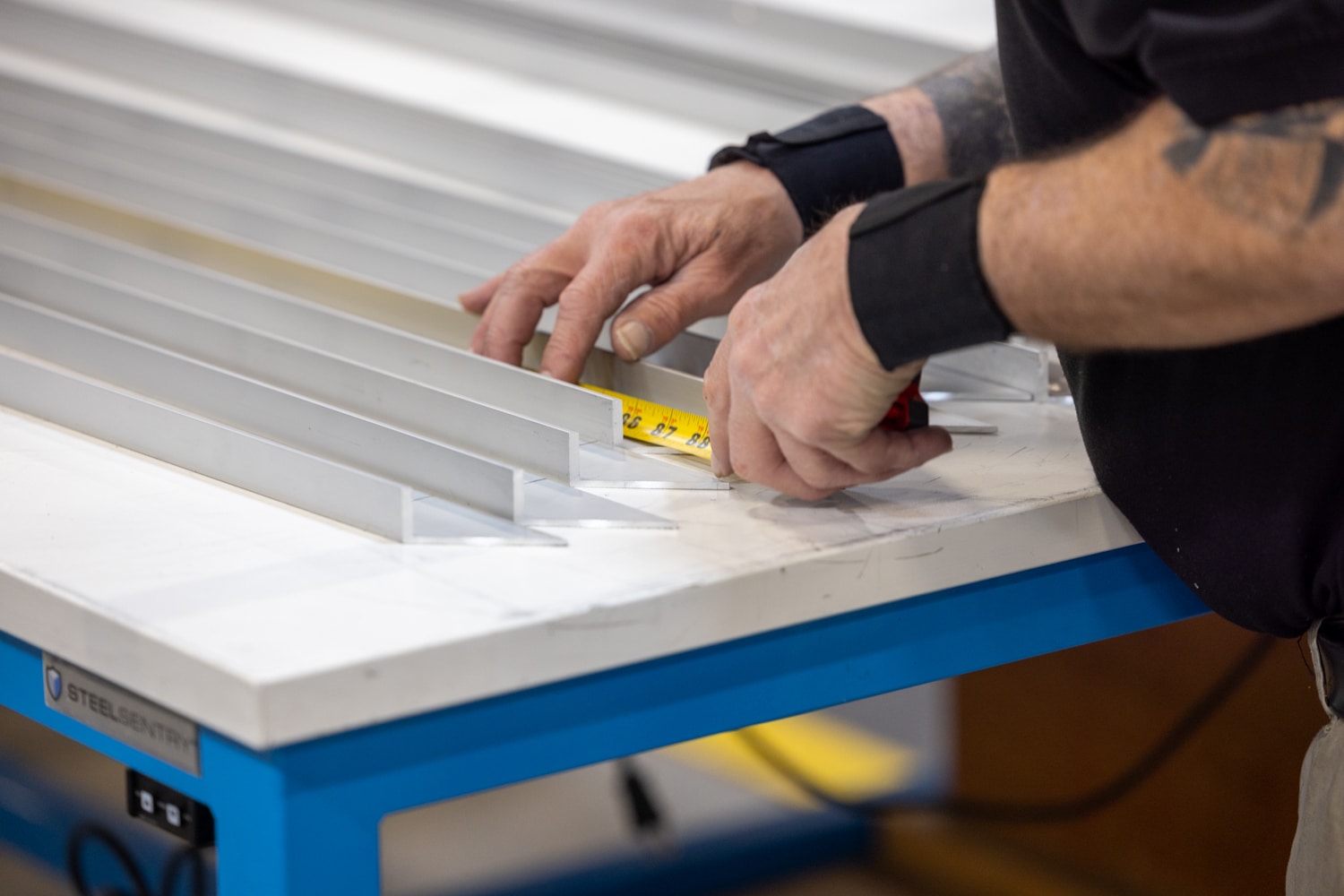 A manufacturer measuring metal components within a cleanroom